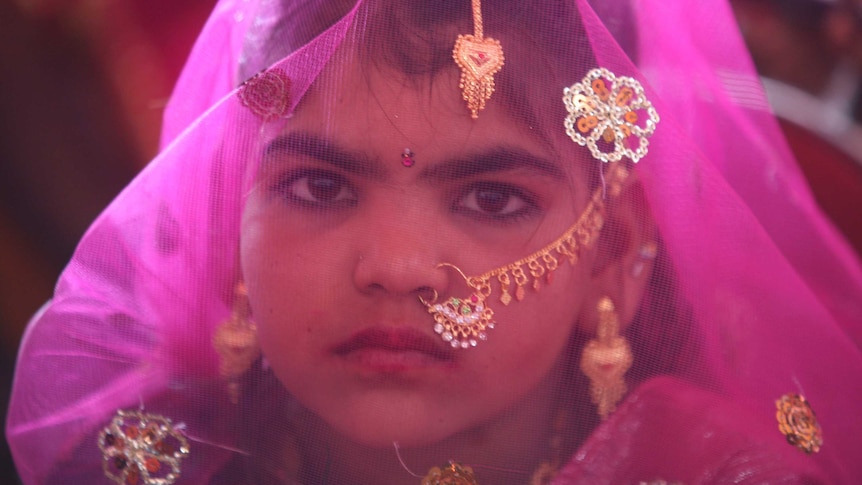 An Indian girl from the Saraniya community dressed up in pink veil for her engagement ceremony.