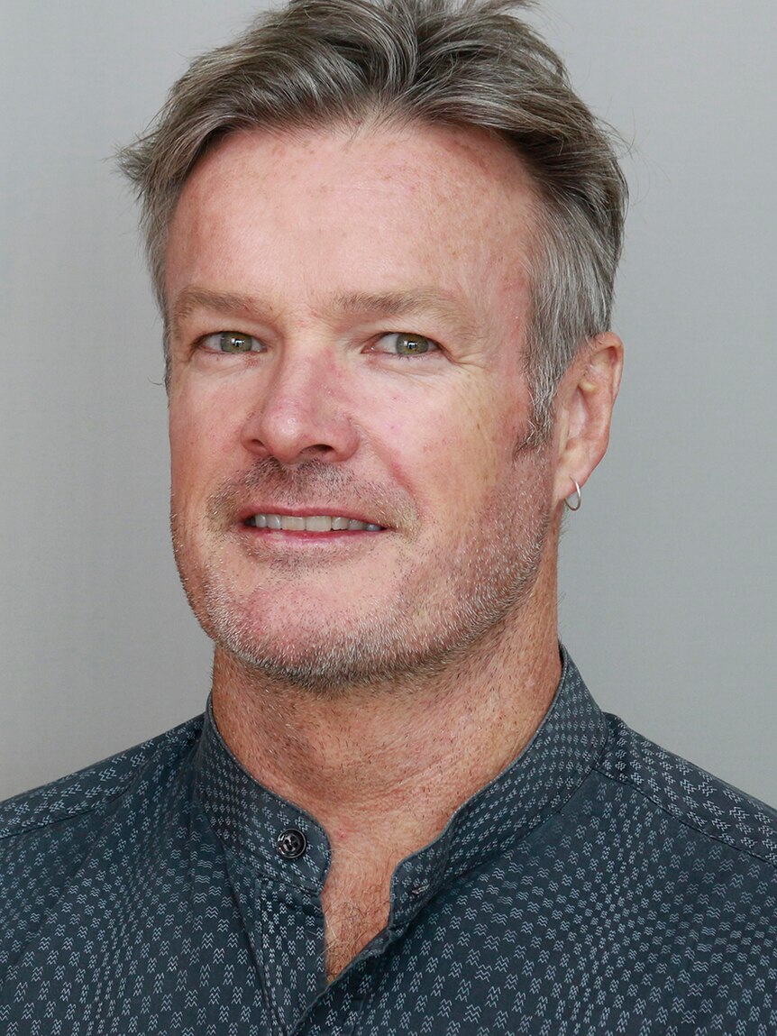 A portrait shot of a man with grey hair.