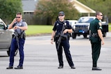 Police officers block off a road after a shooting of police in Baton Rouge.