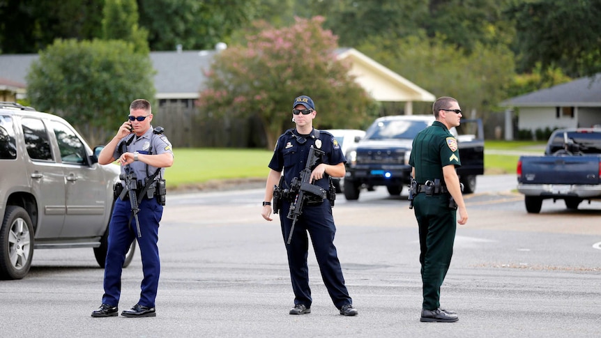 Police officers block off a road after a shooting of police in Baton Rouge.