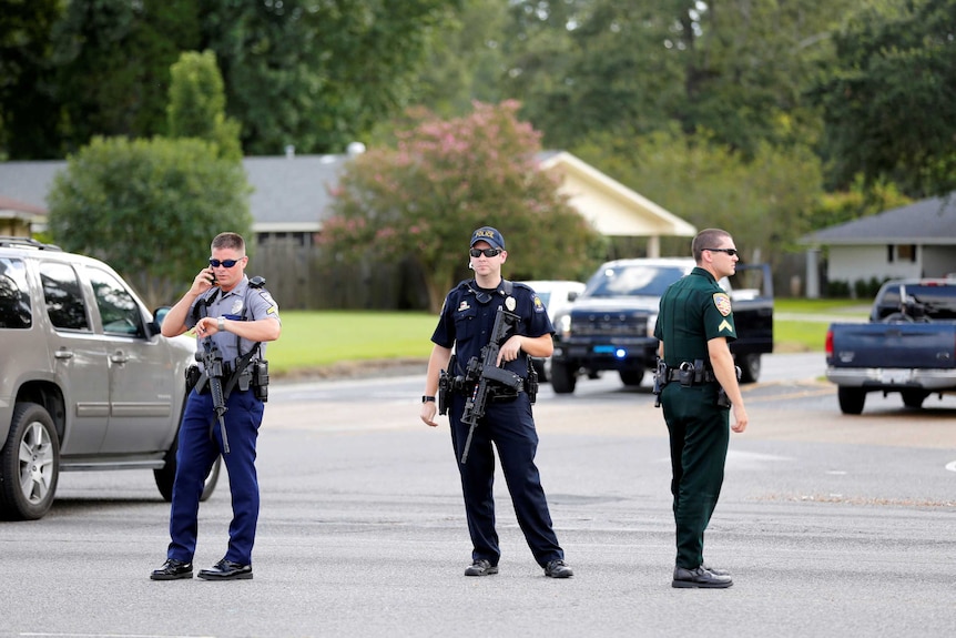 Police officers block off a road after a shooting of police in Baton Rouge.