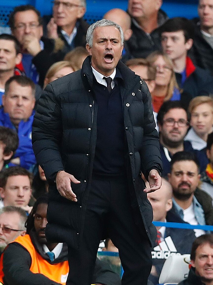 Jose Mourinho looks on during United's loss to Chelsea