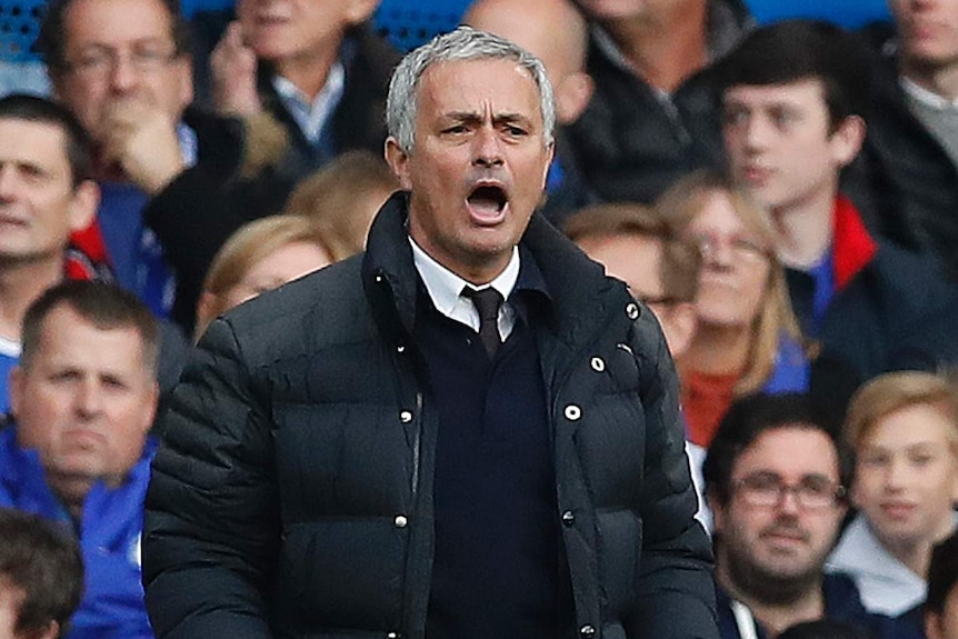 Jose Mourinho stands pitch side during a match.