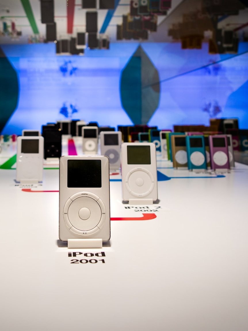 A collection of Apple iPods sit upright in a display cabinet at an Apple museum in Prague