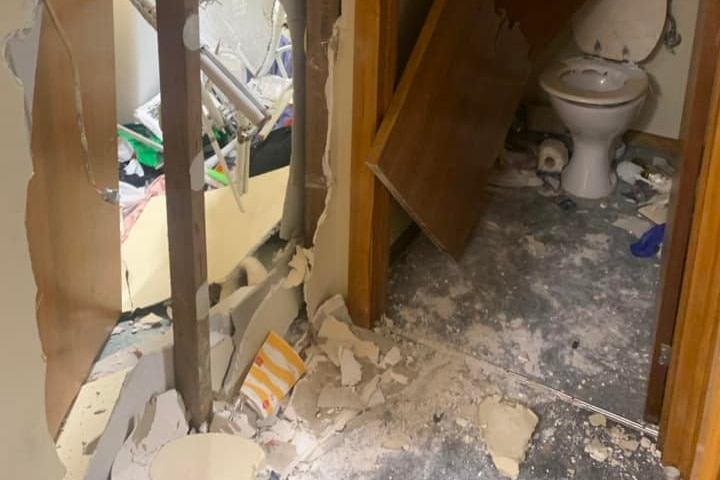 social housing unit - toilet and walls wrecked