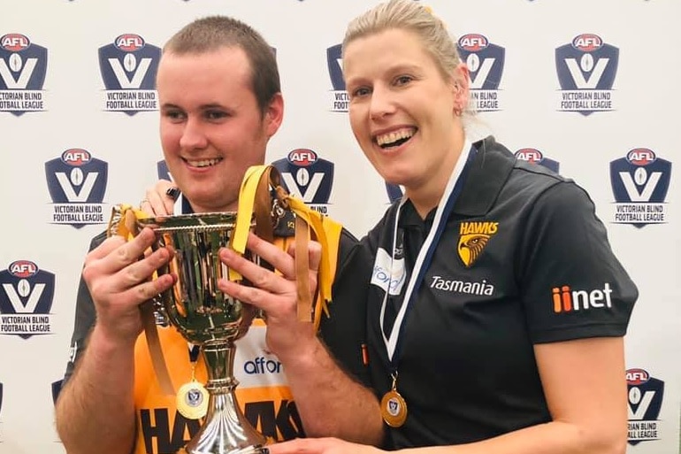 a man with a trophy standing next to a woman who has a sports medal around her neck Ausnew Home Care, NDIS registered provider, My Aged Care