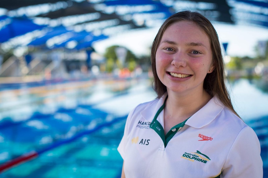 Maddie Elliot stands in front of the pool after a hard day's training.