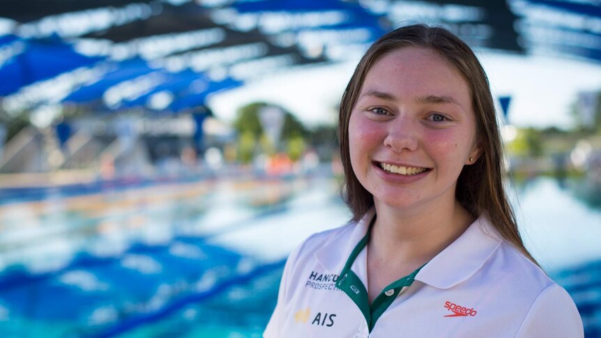 Maddie Elliot stands in front of the pool after a hard day's training.