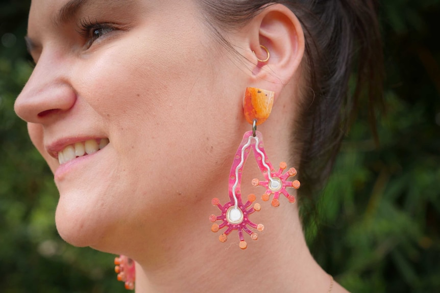 Lady wearing bright earrings.