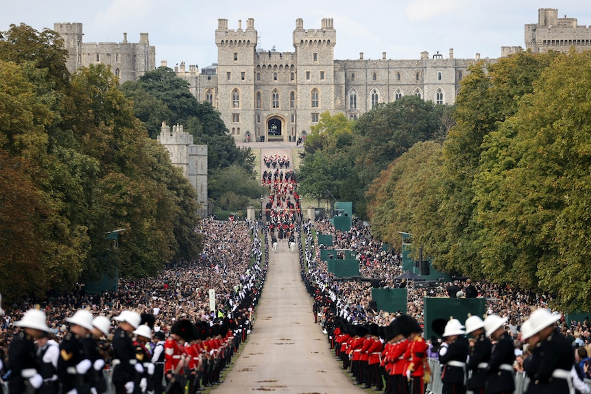 A wide shot of the procession making its way over Long Walk in direction of Windsor Castle.