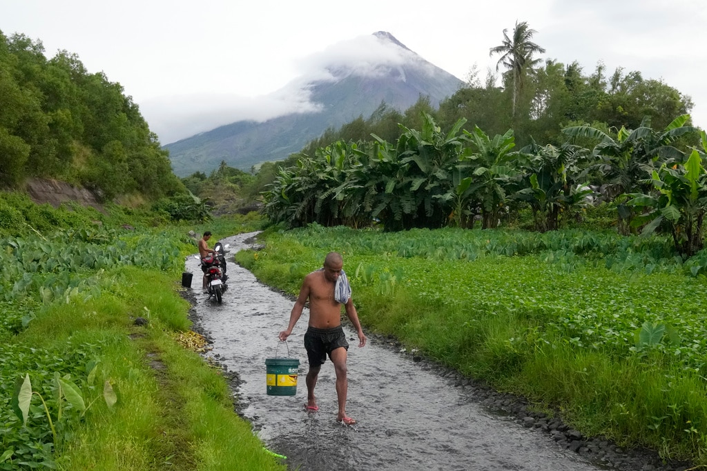 A man walks along a stream near Mayon volcano in Bonga, Legaspi city.