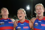 Bonnie Toogood (L), Katie Brennan (C) and Bailey Hunt celebrate the Bulldogs' win over Melbourne.