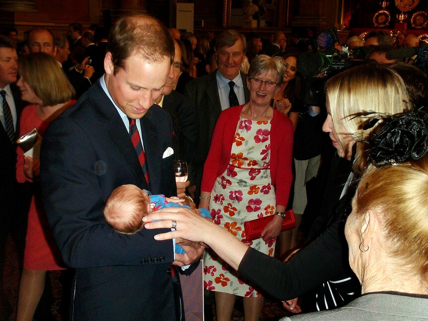 Prince William holds three-week-old Hugo Eric Scott Vicary.