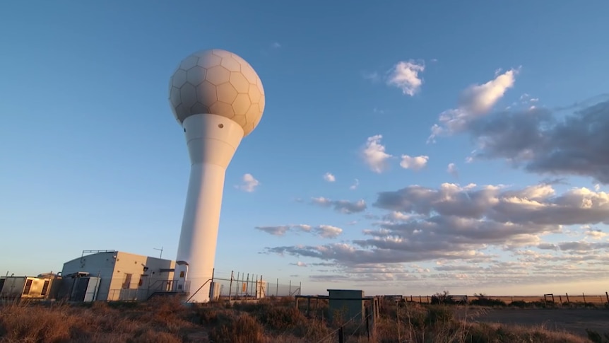 A weather radar that looks like a giant golf ball on a tee set against a blue sky