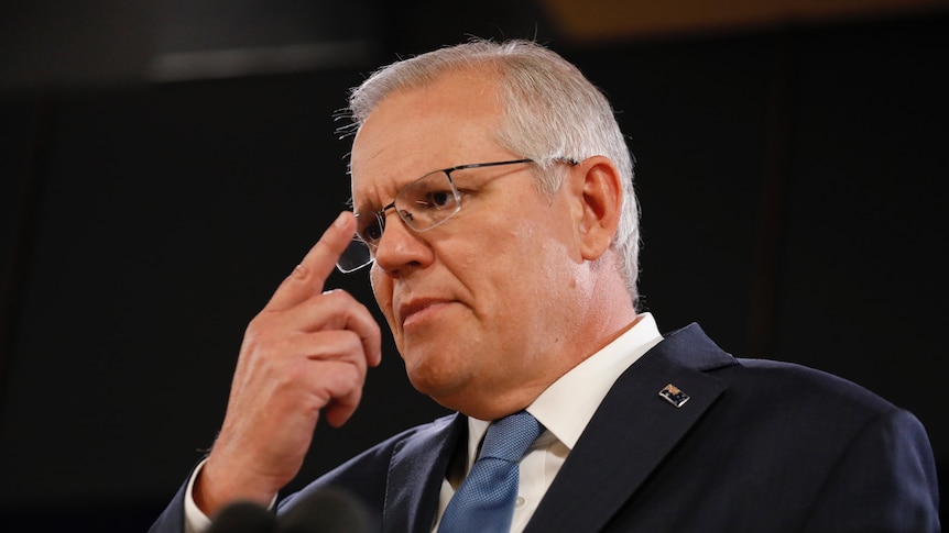 Scott Morrison touches his glasses 