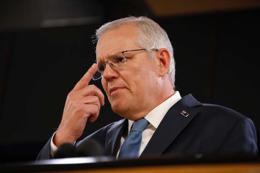 Scott Morrison touches his glasses 