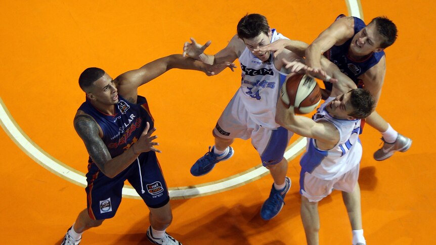 Tight contest ... Diamon Simpson (L) and Daniel Johnson (R) of the 36ers compete with Dillon Boucher (C) and Tom Abercrombie of the Breakers (Morne de Klerk: Getty Images)