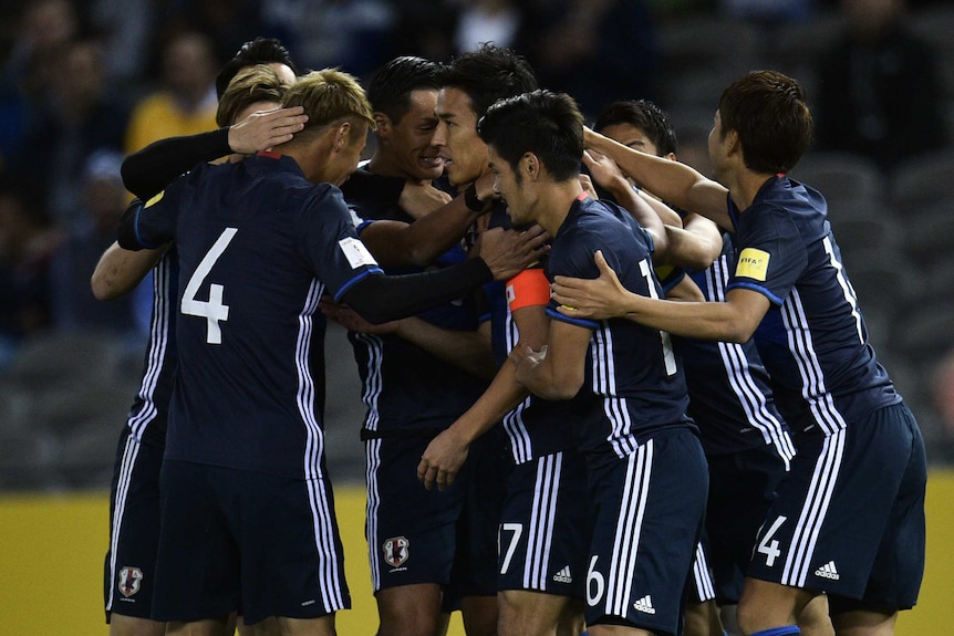 Japanese players celebrate a goal