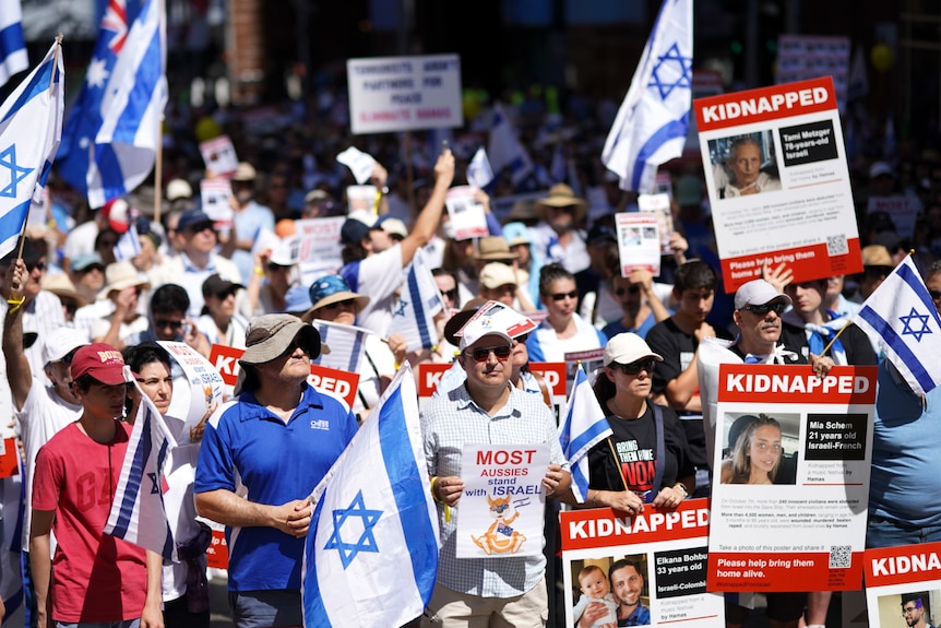Group holds Israeli flag and posters at pro-Israel rally