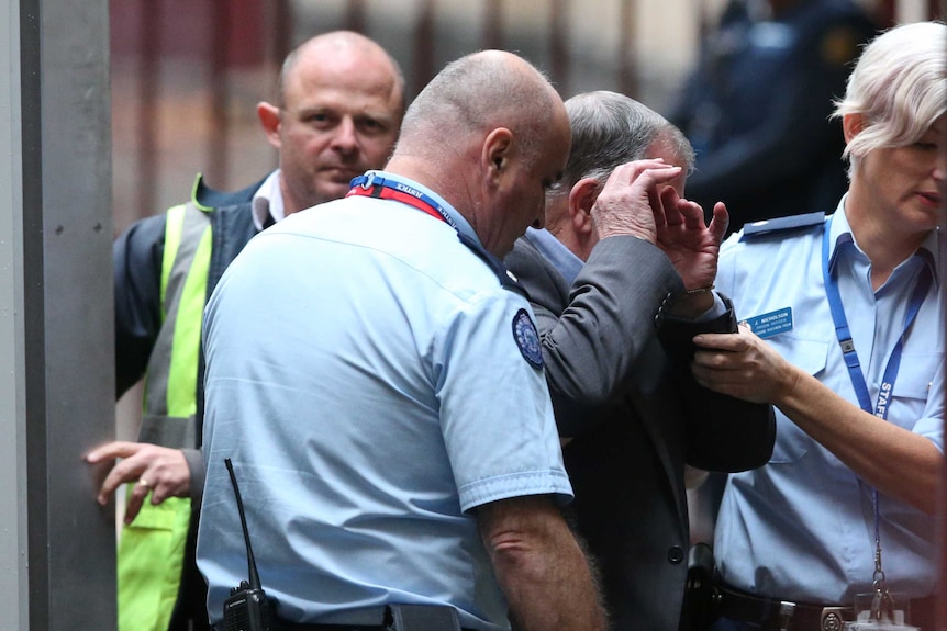 Gregory Keith Davies is led from the prison van to the Melbourne Supreme Court.