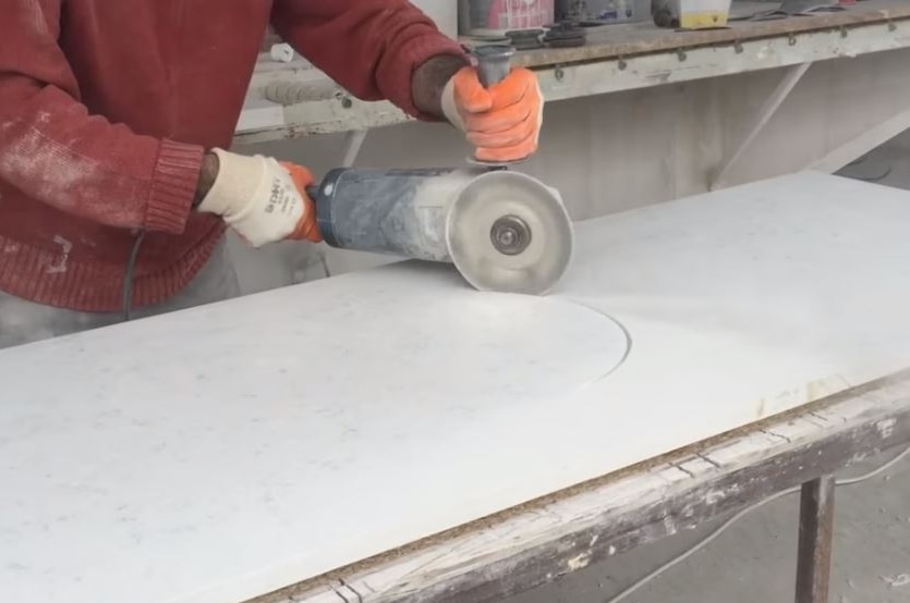 A man cutting stone for a kitchen benchtop.