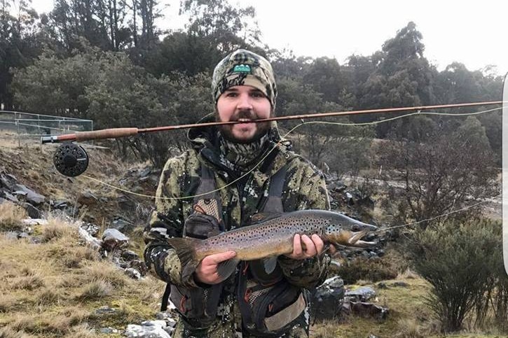 Man with a brown trout.