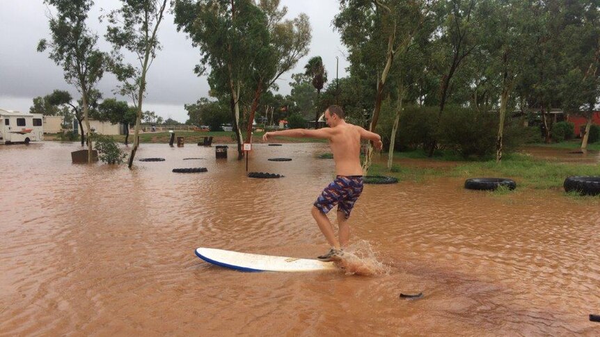 Surfing at the flooded campgrounds of Curtin Springs in Central Australia