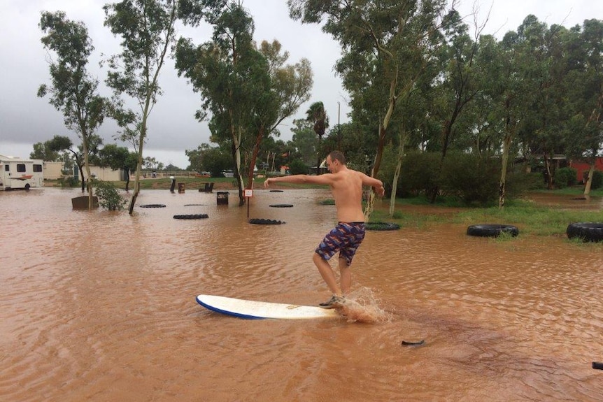 Surfing at the flooded campgrounds of Curtin Springs in Central Australia