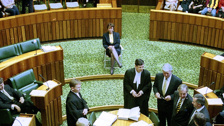 Peg Putt sits on a fold-up chair in the House Of Assembly.