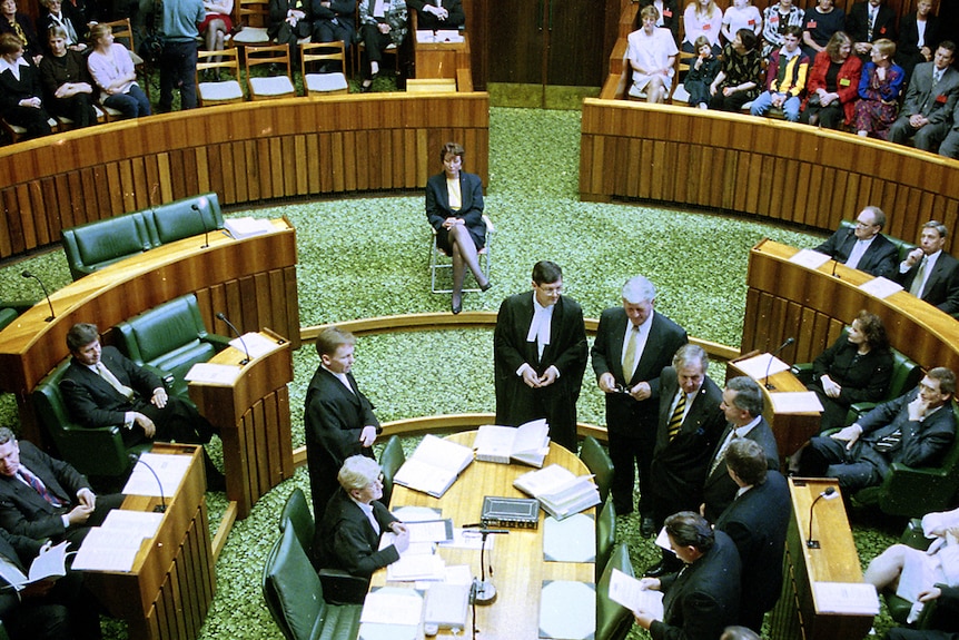 Peg Putt sits on a fold-up chair in the House Of Assembly.