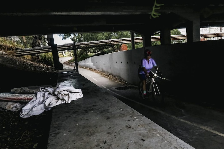 Cyclist riding alone through a tunnel