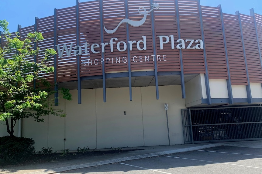 A big sign saying Waterford Plaza shopping centre