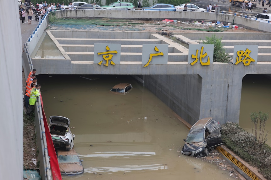 Flooded roadway with ruined cars