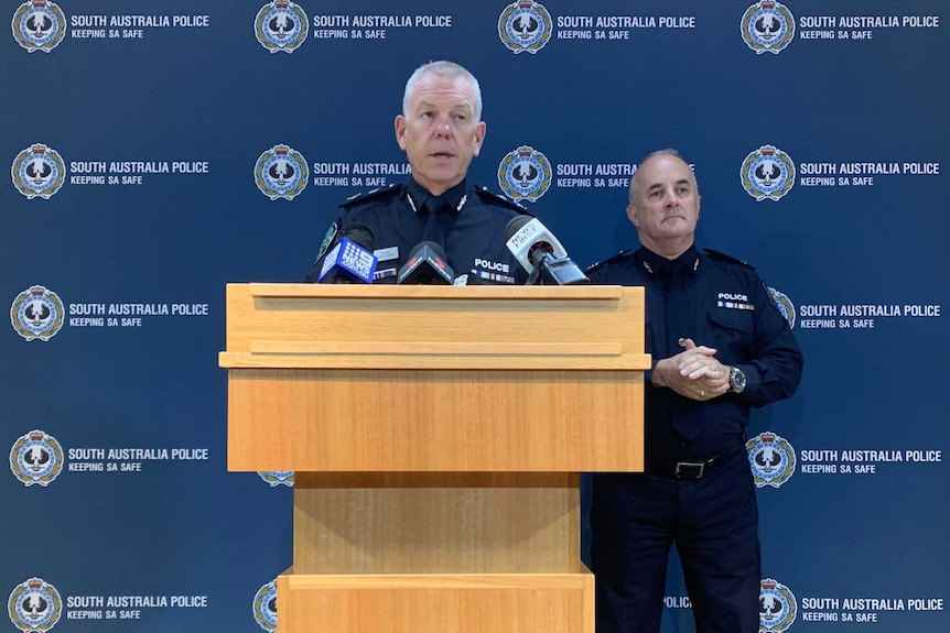 Two senior SA Police officers standing at a lectern