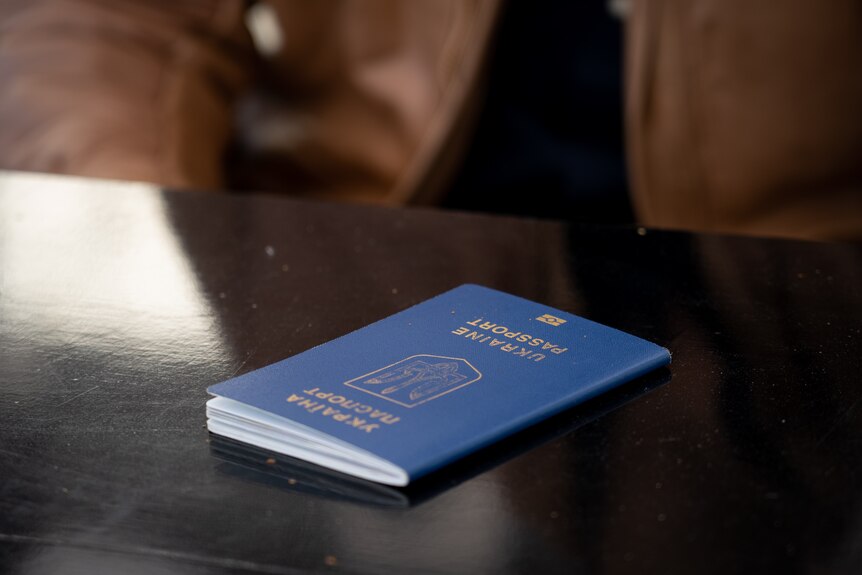 A Ukrainian passport on a table.