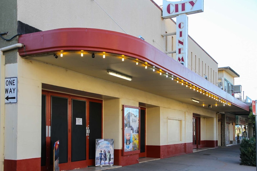 An outside view of the Silver City Cinema, a beige building with red trim.