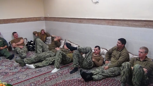 The American sailors sitting in a unknown place in Iran.