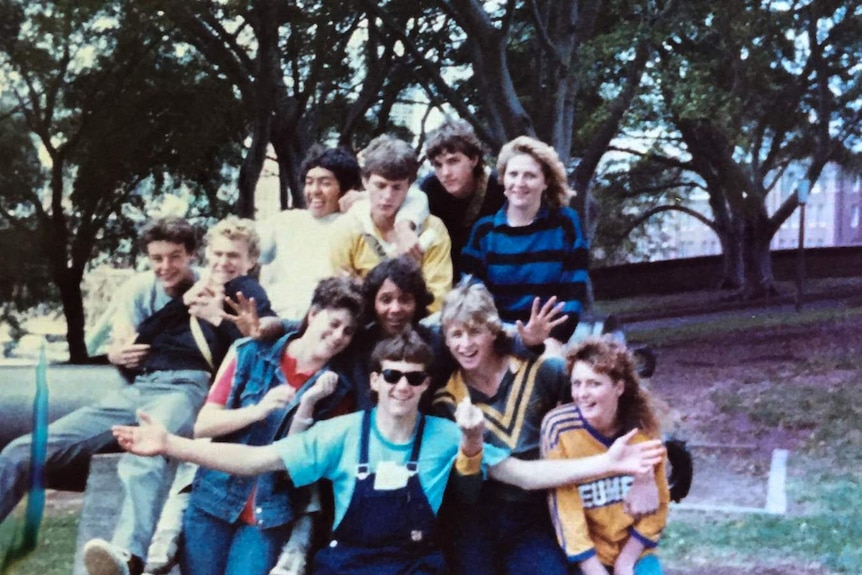 A group of young teens group together for a photo, Mark is front and centre.