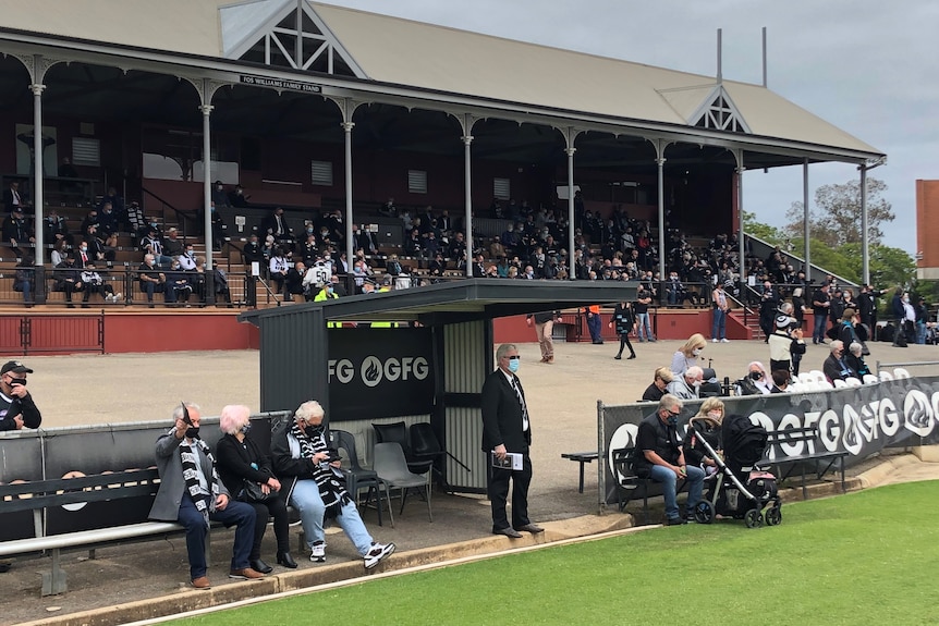 A crowd of mourners at Alberton Oval for the state funeral of Russell Ebert.