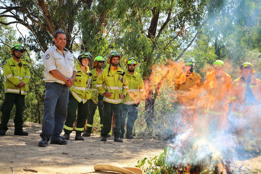 A fire being lit with traditional methods for use in back burning.