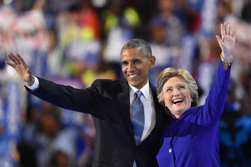 US President Barack Obama waves with US Presidential nominee Hillary Clinton