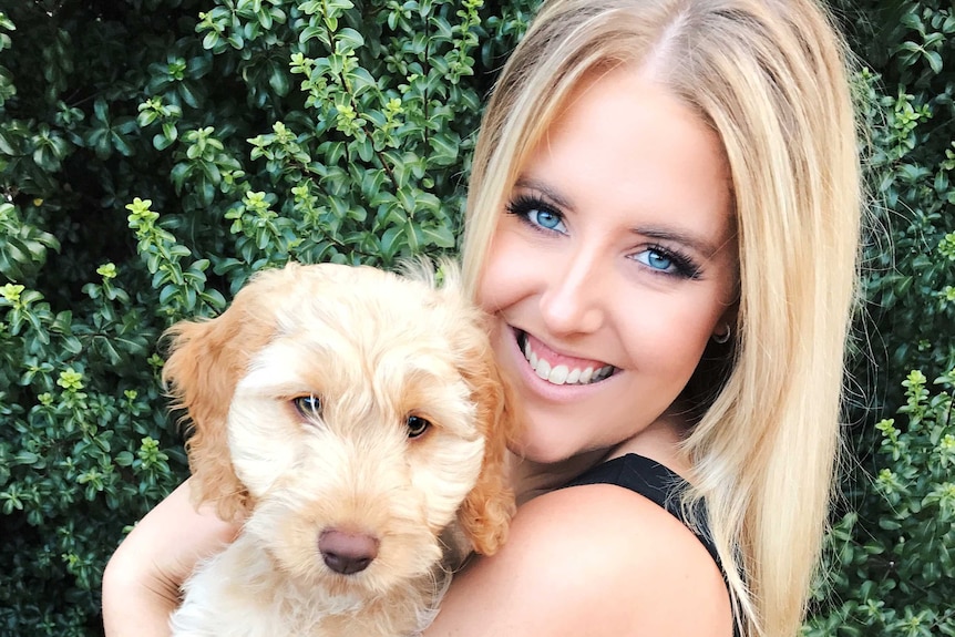 Rachelle Flynn holds her dog Alfie