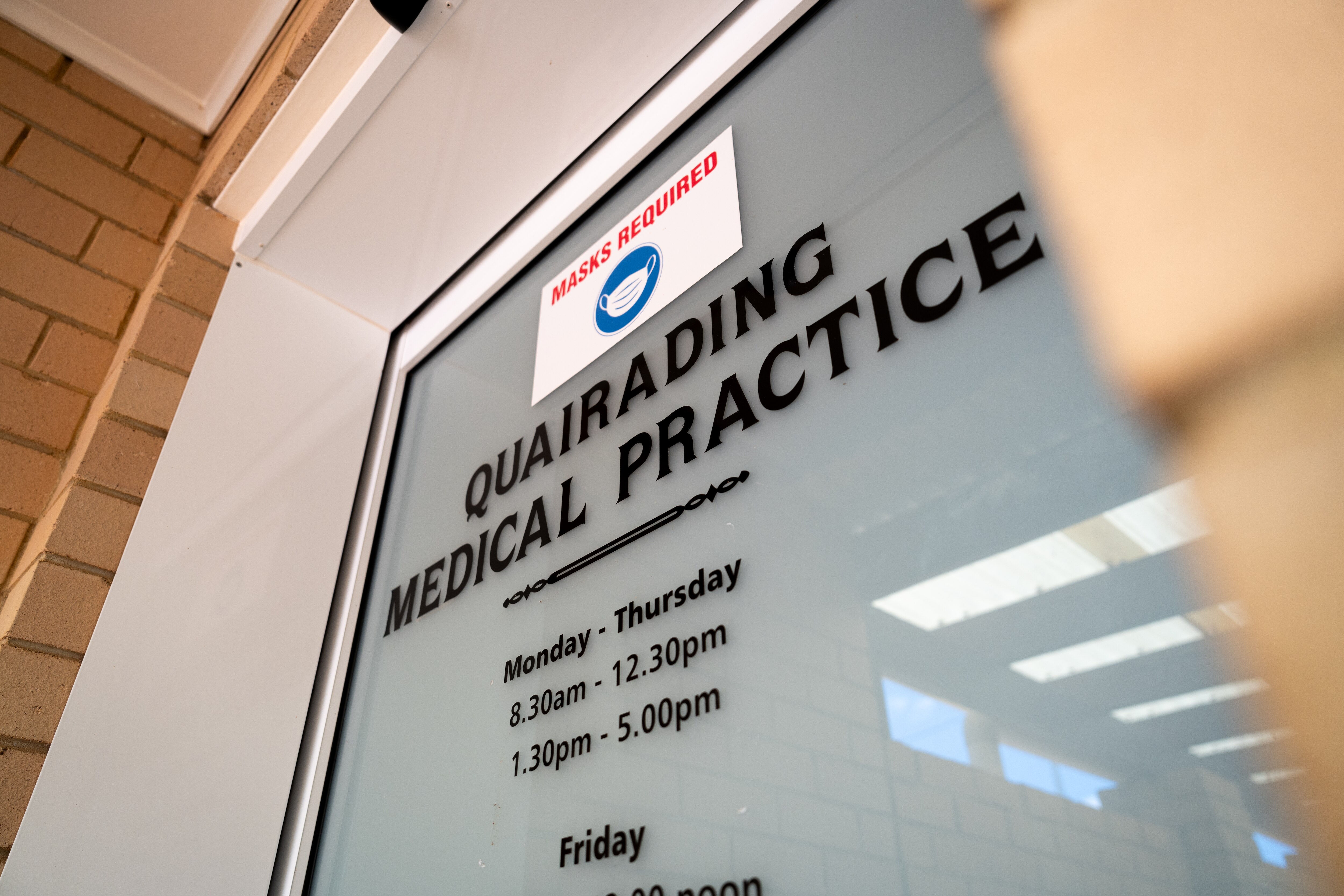 Glass door entrance of a clinic with Quairading Medical Practice written on the front.
