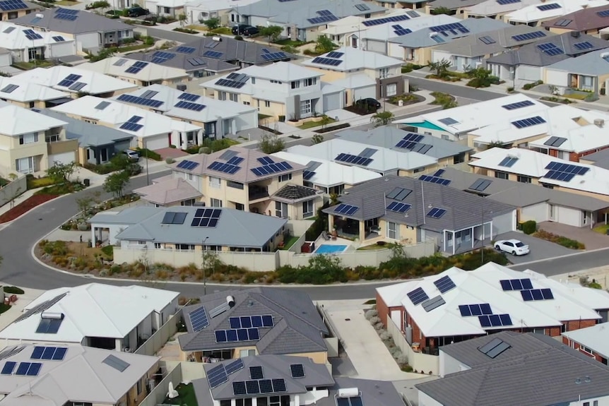 Solar panels on homes in a new suburb from a drone