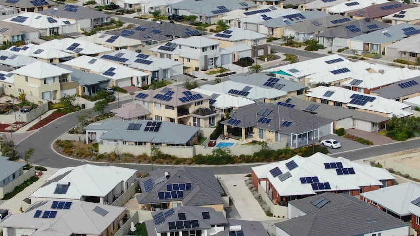 Solar panels on homes in a new suburb from a drone
