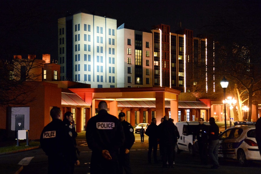 French police stand guard outside a Disneyland Paris hotel.