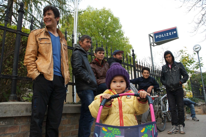 Asylum seekers from the Hazara region of Afghanistan wait for assistance outside the police station in the Austrian town of Traiskirchen.