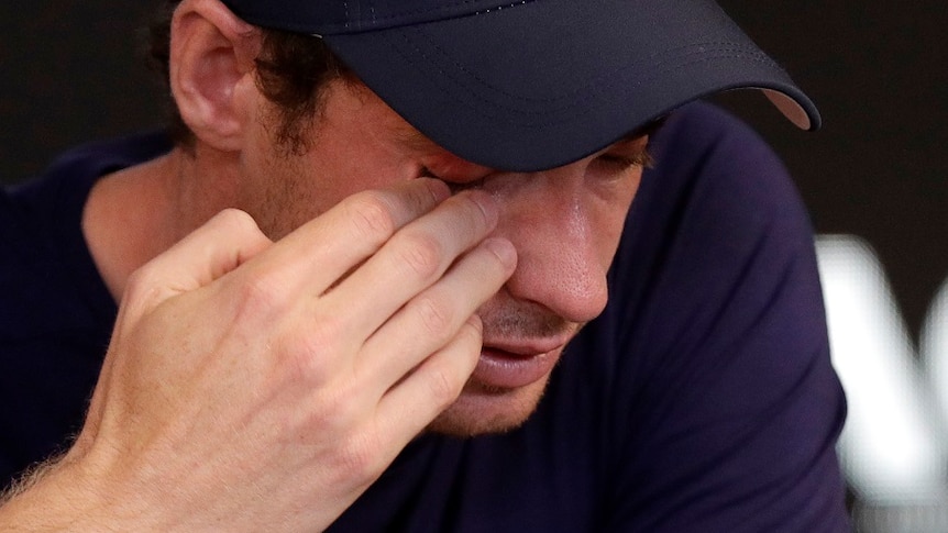 Britain's Andy Murray wipes tears from his face during a press conference.