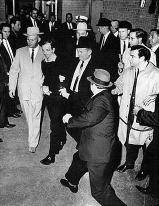 Lee Harvey Oswald is shot by Jack Ruby in the basement of Dallas Police Headquarters.