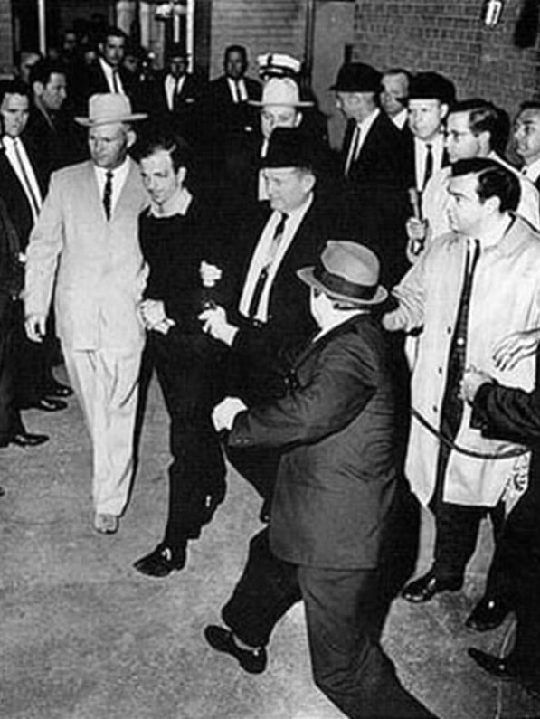 Lee Harvey Oswald is shot by Jack Ruby in the basement of Dallas Police Headquarters.